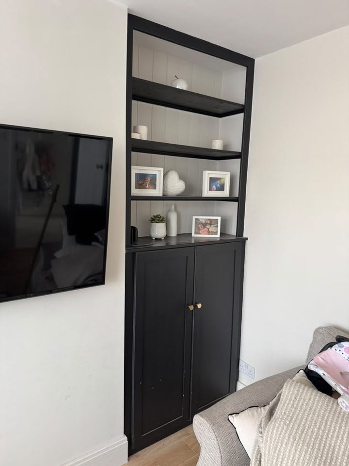 The original fitted cabinet on the other side of the chimney breast, painted black