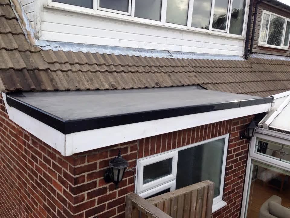 Black rubber flat roof on a single storey brick extension