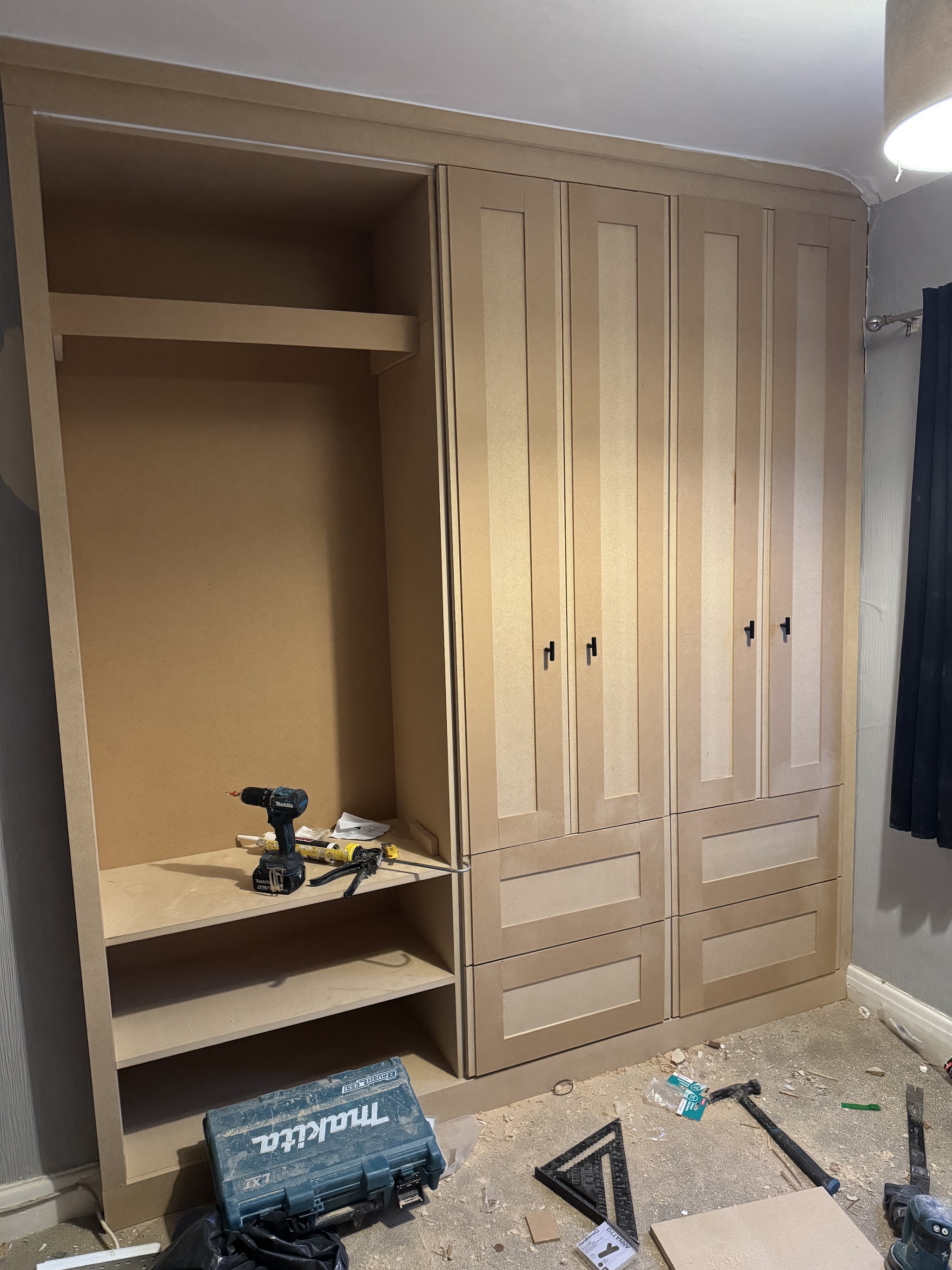 Fitted wardrobe being built in a bedroom