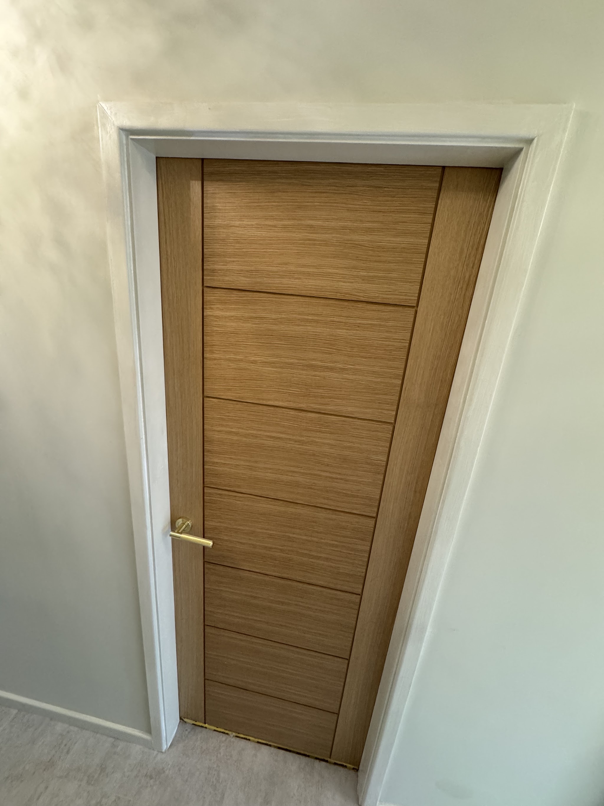 Oak internal door fitted in a hallway